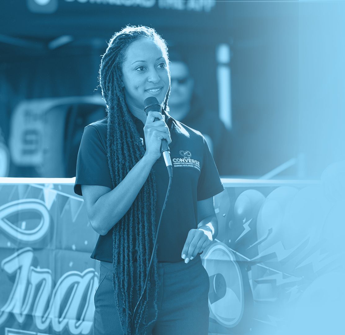 Jessica Hannah speaking into a microphone at a Converse community event