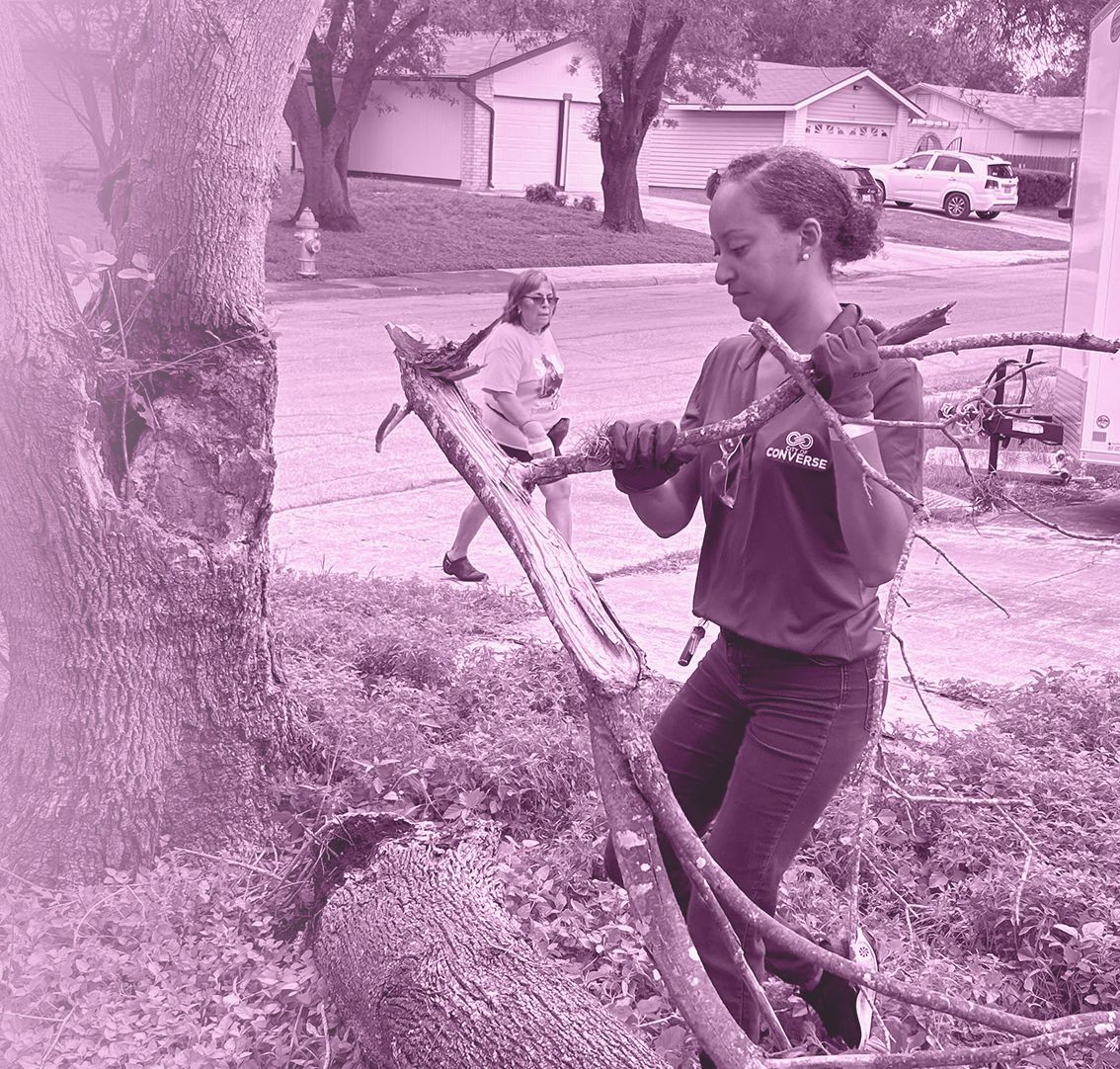 Jessica Hannah clearing fallen branches with neighbors during a community cleanup